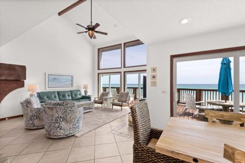 a living room with a couch and a table at Sun 'n Surf in Inlet Beach