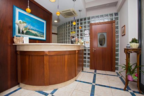 a lobby with a bar in a building at Hotel lo Squalo in Grottammare