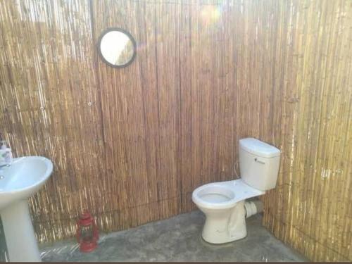 a bathroom with a toilet and a sink at Pop Lamont Camp in Chobe