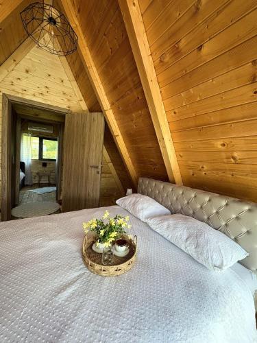 a bedroom with a bed with a tray with flowers on it at Vila Ahouse in Jagodina