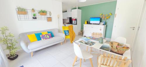 a living room with a couch and a table at Fleur De Cerisier Vendée in Challans