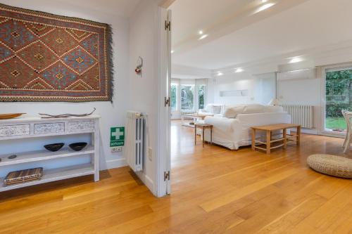 a bedroom with a bed and a living room at Villa Bista Eder in Hondarribia
