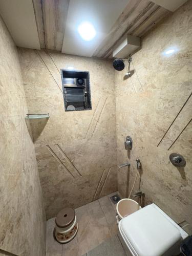 a bathroom with a shower with a toilet in it at Hotel Falcon Ulhasnagar by Hotelist in Kalyan