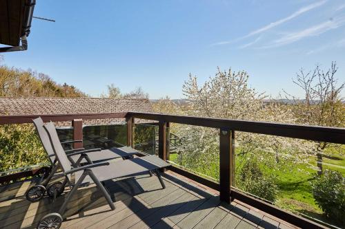 a chair sitting on a deck with a view at Host & Stay - Beech Lodge in Belton