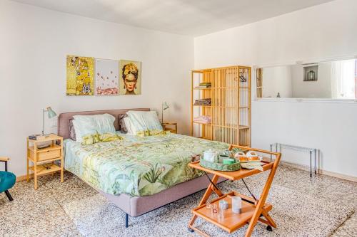 a bedroom with a bed and a table in it at Tuscan Treasure Tower in Colle di Val d'Elsa