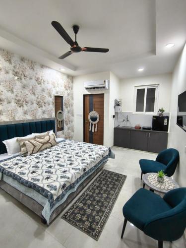 a bedroom with a bed and a ceiling fan at Cozy Cove in Jaipur