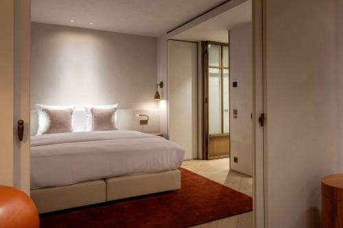 a bedroom with a large white bed and a mirror at O'Ciel 24 - Exceptional 24th floor Residence - Ostend in Ostend
