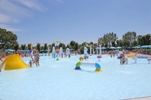 a group of people playing in a water park at San Francesco Camping Village in Desenzano del Garda