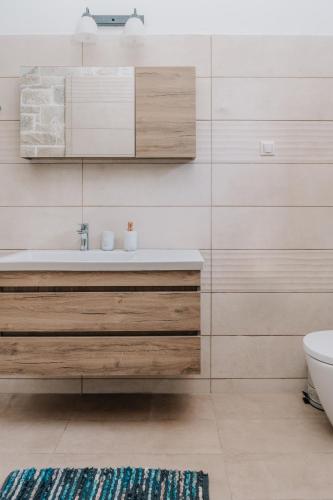 a bathroom with a sink and a toilet at Guince House by All About Paxos in Oziás