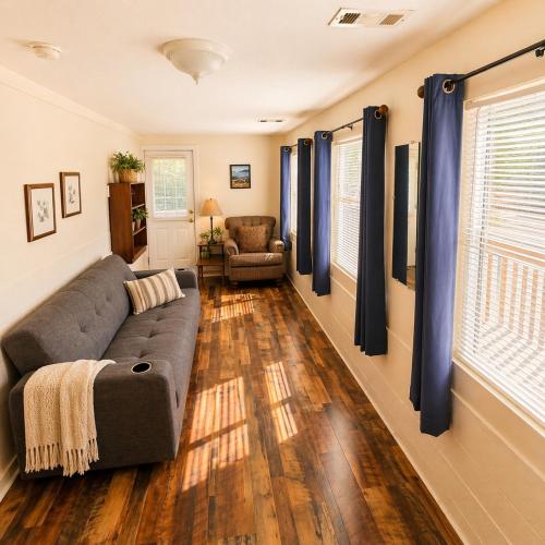 a living room with a couch and blue curtains at Buccaneer Bay Bungalow #6 in Sunrise Beach