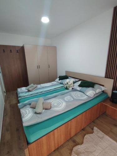 a large bed with stuffed animals on it in a room at Silver Moon 1 in Veliko Gradište
