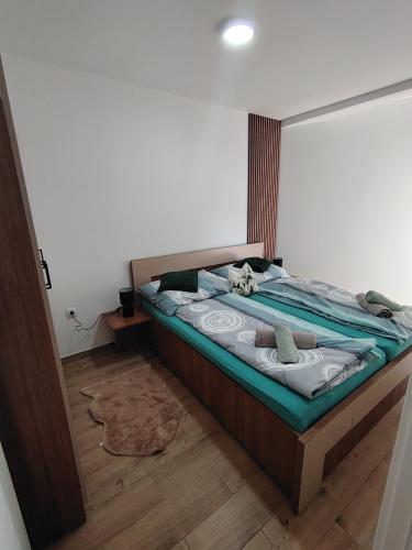 a bedroom with a bed with a mirror on the wall at Silver Moon 1 in Veliko Gradište