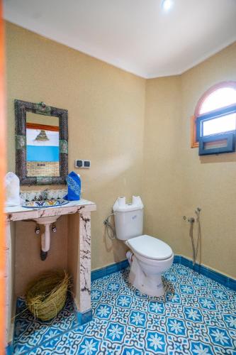 a bathroom with a toilet and a sink at Le Reflet D'Imlil in Imlil