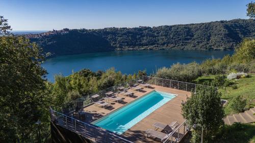 a swimming pool with a view of a lake at VILLA GIULIA 8, Emma Villas in Nemi