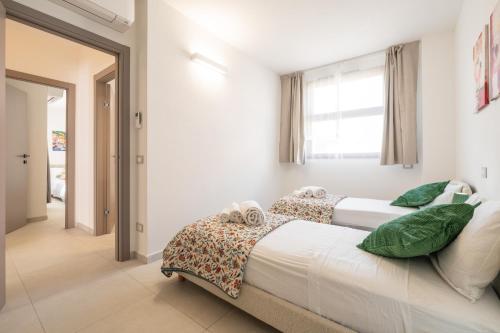 a bedroom with two beds and a window at Domus Luna in Teulada