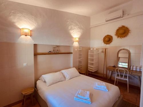 a small bedroom with a white bed and a table at Quinta da Vala - Veranda Suite 1 in Porches