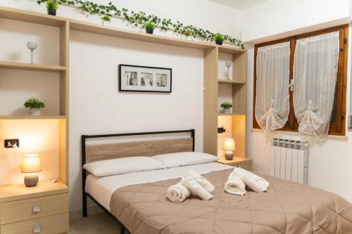 a bedroom with a bed with two pillows on it at Al Civico 23 in Castiglione del Lago