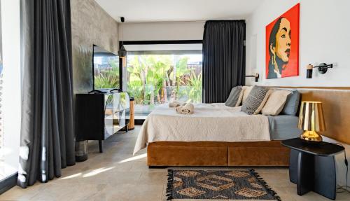 a bedroom with a bed with a dog laying on it at Villa Ha Taew in Sant Josep de sa Talaia