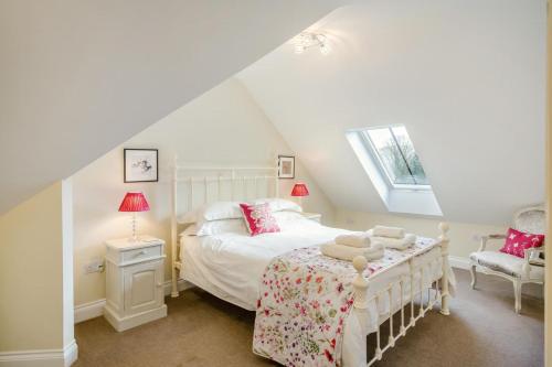 a bedroom with a white bed and a window at 3 Bed in Langholm oc-c41365 in Langholm
