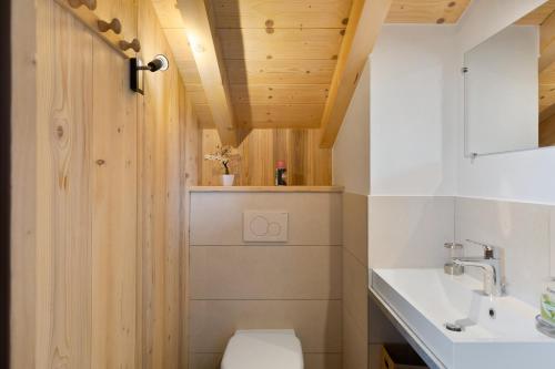 a bathroom with a toilet and a sink at Chalet Individuel - Saflalou in Combloux