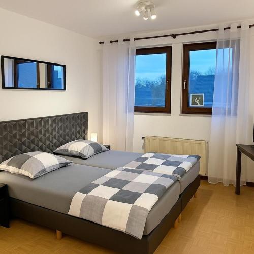 a bedroom with a bed with a checkered blanket at Gasthaus Bidinger in Schoden