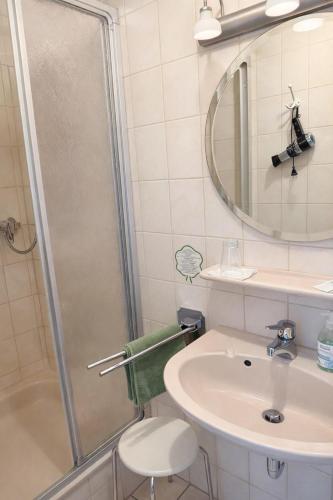a bathroom with a shower and a sink at Gasthaus Bidinger in Schoden