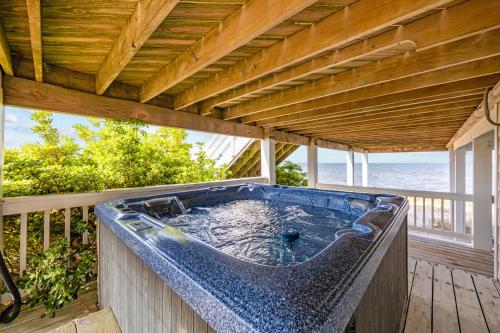 a hot tub on the deck of a house at 7659 - Sound Garden in Avon