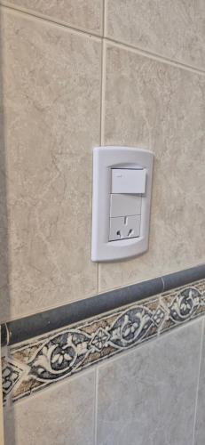 a white electrical box on a tile wall at Continental Hotel in Miramar