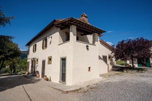 a white building with a brown roof at Il Pozzo degli Angeli in Cortona
