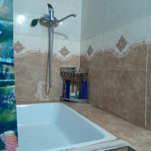 a bath tub in a bathroom with a shower at Le Fortin in Samarkand