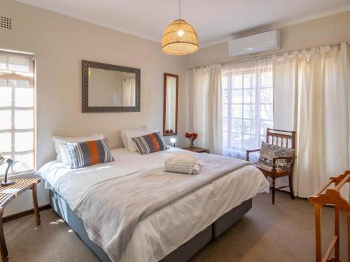 a bedroom with a large bed in a room with windows at The Gentleman in Montagu