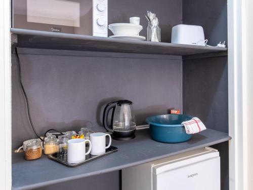 a kitchen shelf with a counter top with dishes and a mixer at The Gentleman in Montagu