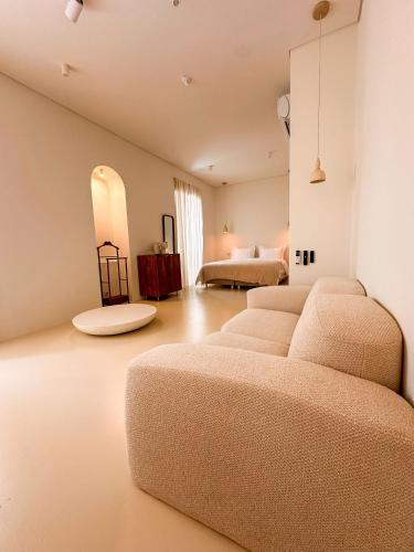 a living room with four beds and a couch at Terracotta House in Porto Santo