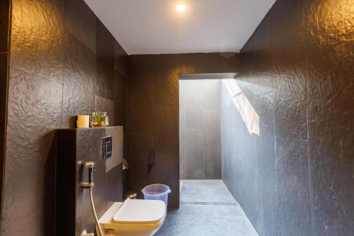 a bathroom with a toilet and a sink at DARZA LUXURY RESORTs in Coimbatore