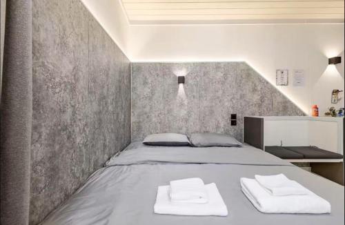 a bedroom with a bed with two towels on it at Coolplay house in Bangkok
