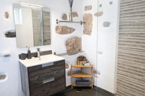 a bathroom with a sink and a mirror at Apartment Estrella Nina in La Ampuyenta