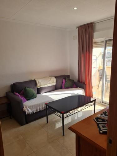 a living room with a couch and a table at Casa Ingrid in San Fulgencio