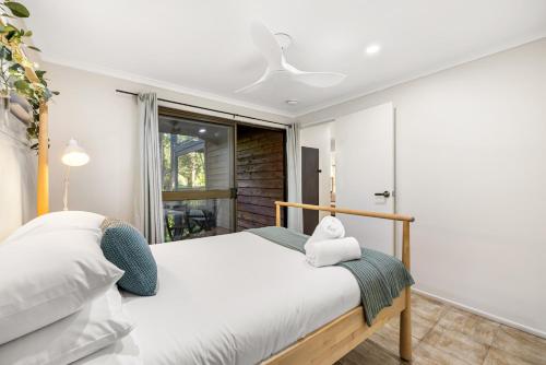 a bedroom with a bed and a window at The Bamboo Base at Buderim in Buderim