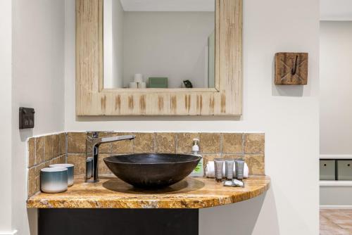 a bathroom counter with a sink and a mirror at The Bamboo Base at Buderim in Buderim