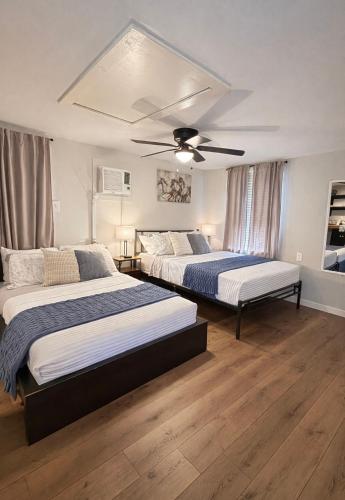 a bedroom with two beds and a ceiling fan at Western Studio in Houston