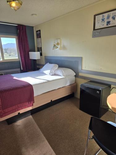 a hotel room with a bed and a window at Hatch Station Bryce Canyon in Hatch