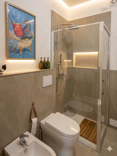 a bathroom with a shower and a toilet and a sink at Feel B&B and more in Saluzzo