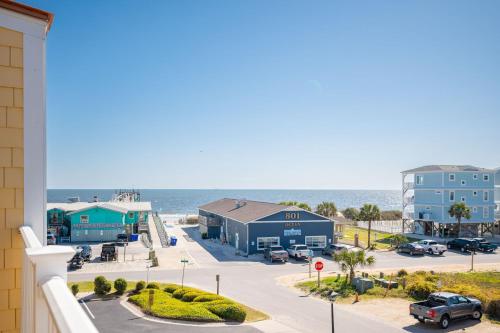 a view of the beach from the balcony of a condo at Sea Tales by Oak Island Accommodations in Oak Island
