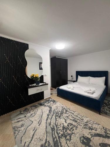 a bedroom with a large bed and a rug at Dejani Guest House in Pogradec
