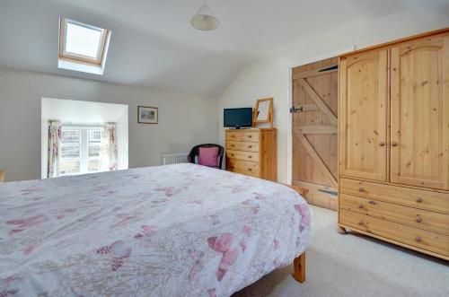 a bedroom with a large bed and wooden cabinets at 2 Bed in Pickering oc-y012 in Pickering