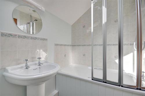 a white bathroom with a sink and a shower at 2 Bed in Pickering oc-y012 in Pickering