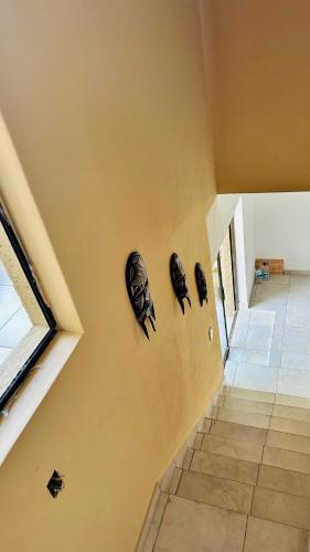 a hallway with two masks on a wall at Spadade View in Roodepoort
