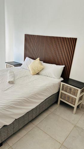 a large bed with two pillows on top of it at Spadade View in Roodepoort