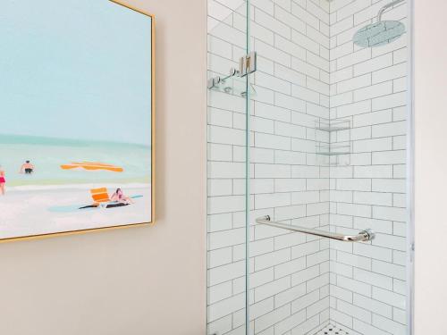 a bathroom with a shower with a picture of the beach at Alwil Apartment 11 in Struisbaai