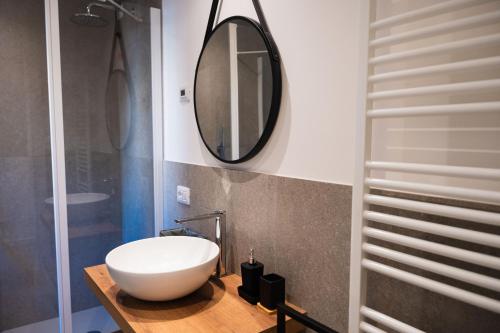 a bathroom with a white sink and a mirror at Suite Prestige Apartment in Torri del Benaco